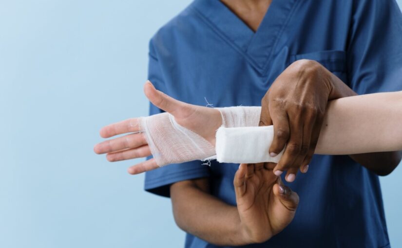 a person getting his hand bandaged
